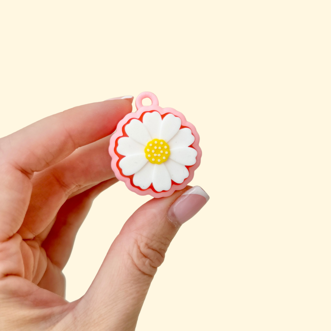 Flower-shaped clicker fidget toy with textured petals and built-in keyring loop.