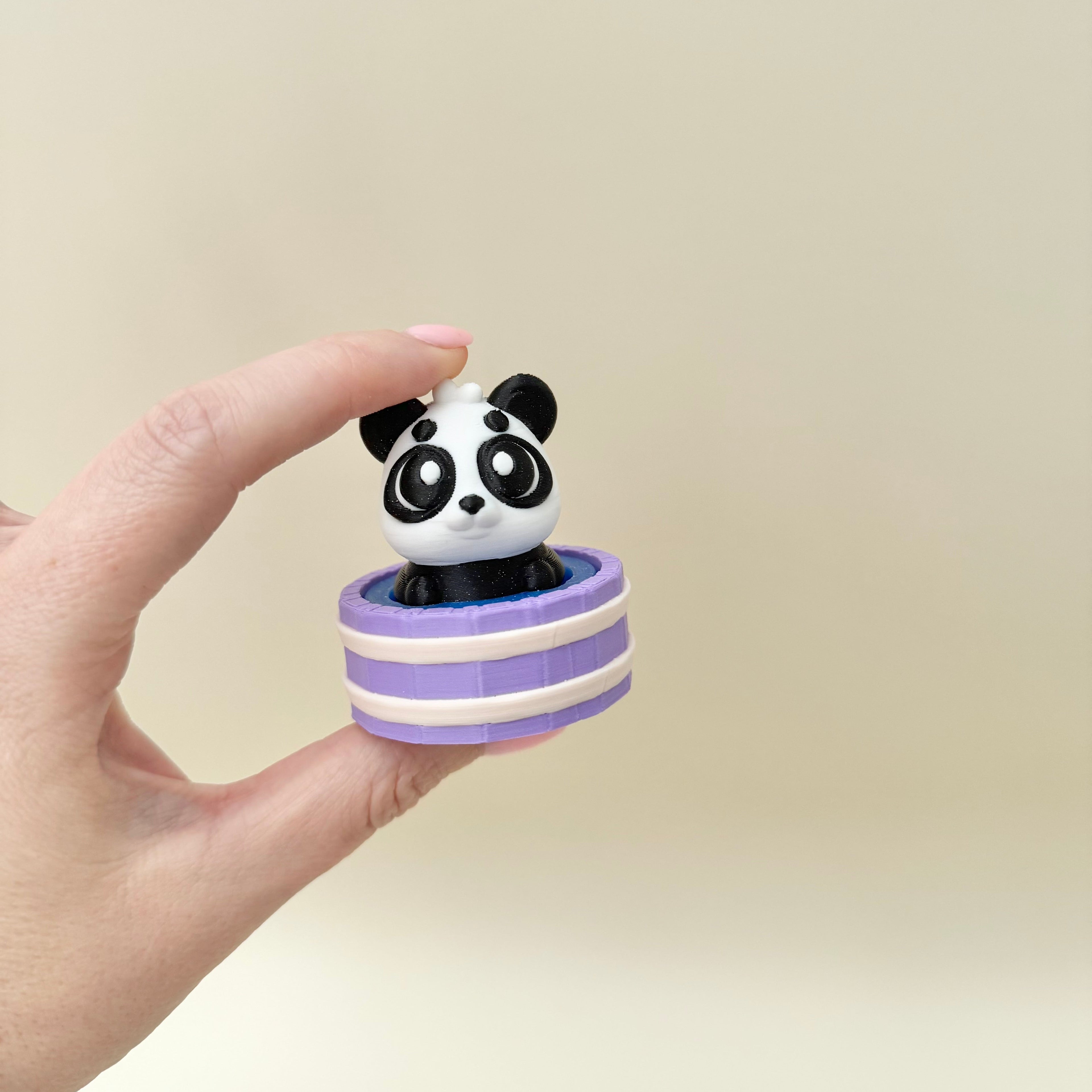 Compact sensory clicker toy with a bear character and smooth press action.
