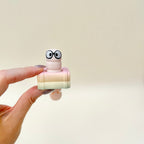 Pocket-sized clicker fidget with moving tail, designed for fidgeting during reading, studying, or work breaks.
