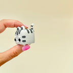 Small cat desk fidget with smooth rounded shape, tactile click feedback and everyday sensory use.