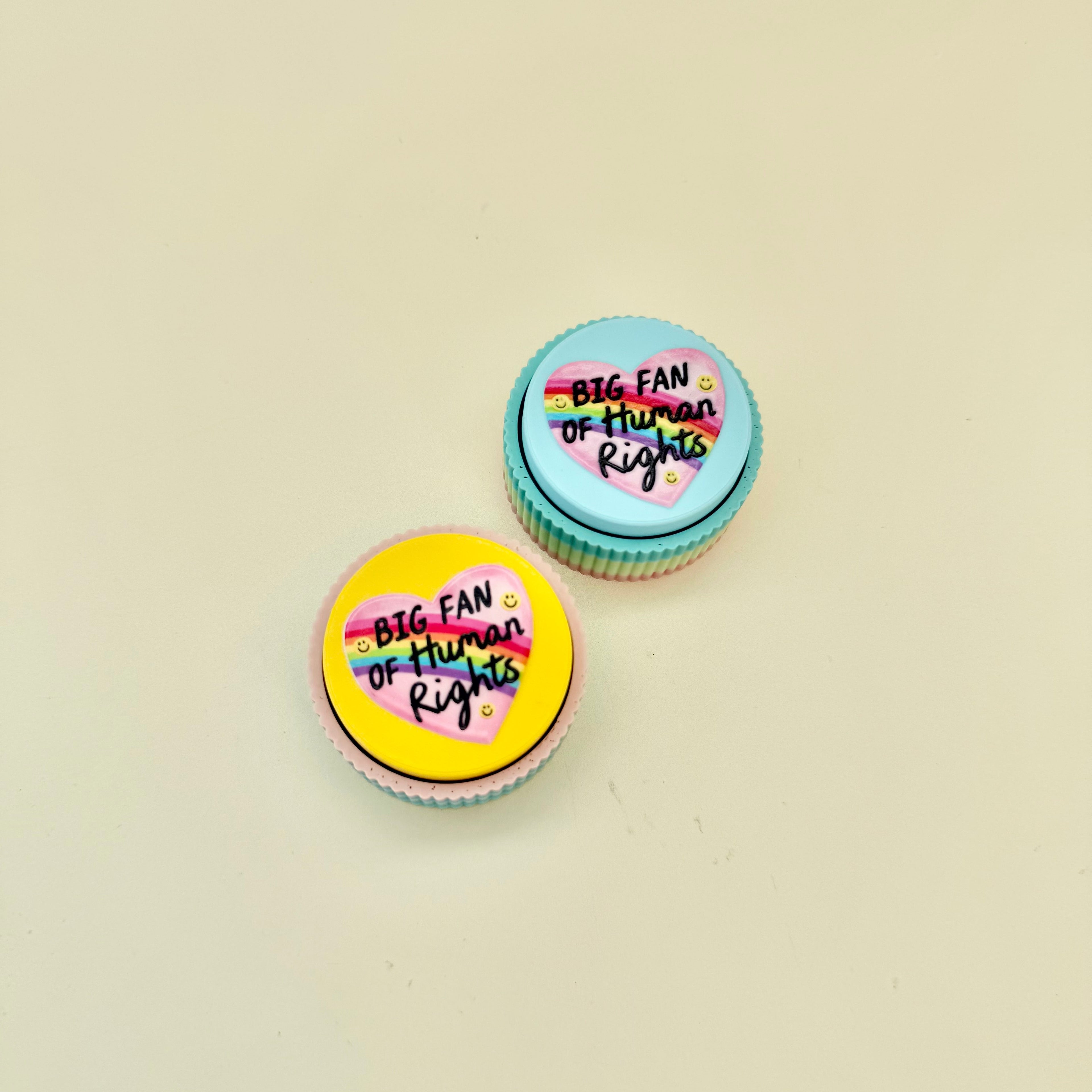 Small desk clicker with bold human rights message, click feedback and sensory regulation support.