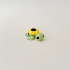 3D-printed turtle toy in soft green and yellow, designed for neurodivergent fidgeters and collectors.