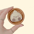 Chunky dumpling clicker fidget in a textured steamer base for satisfying press-down sensory input.
