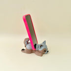 Sleeping dog phone stand with tactile details, designed for practical desk décor and everyday phone use.