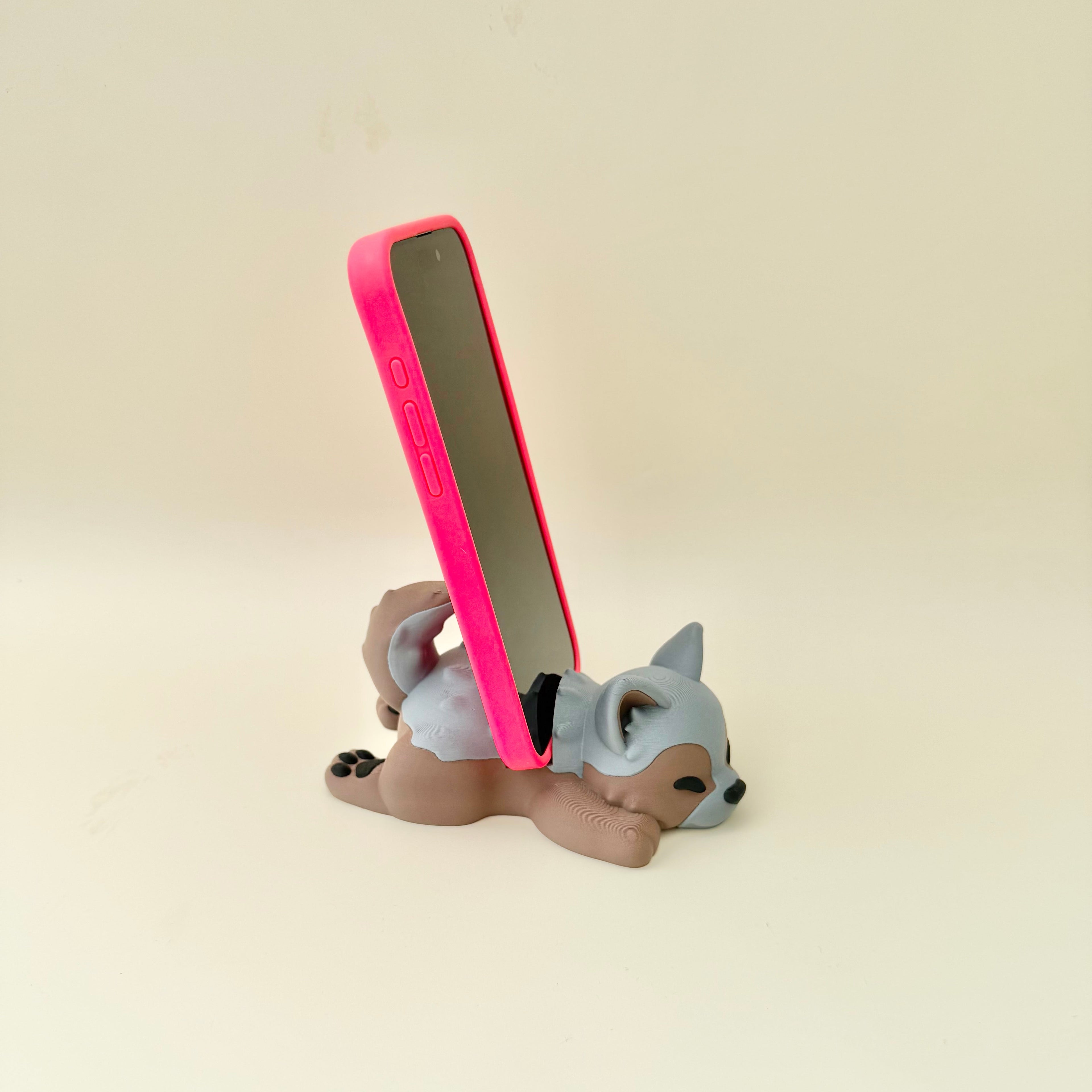 Sleeping dog phone stand with tactile details, designed for practical desk décor and everyday phone use.