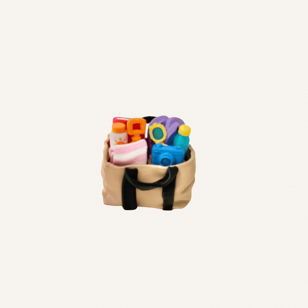 Beach bag fidget with two mechanical clickers and detailed miniature beach accessories.