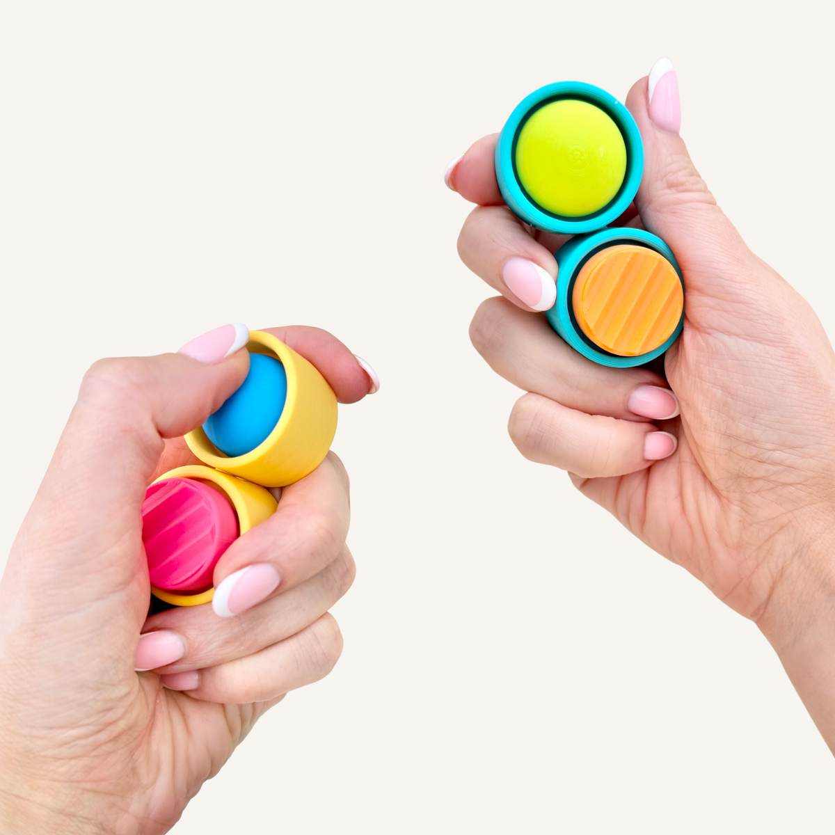 Two-button sensory fidget with a moving centre joint designed to adjust naturally around the hand.