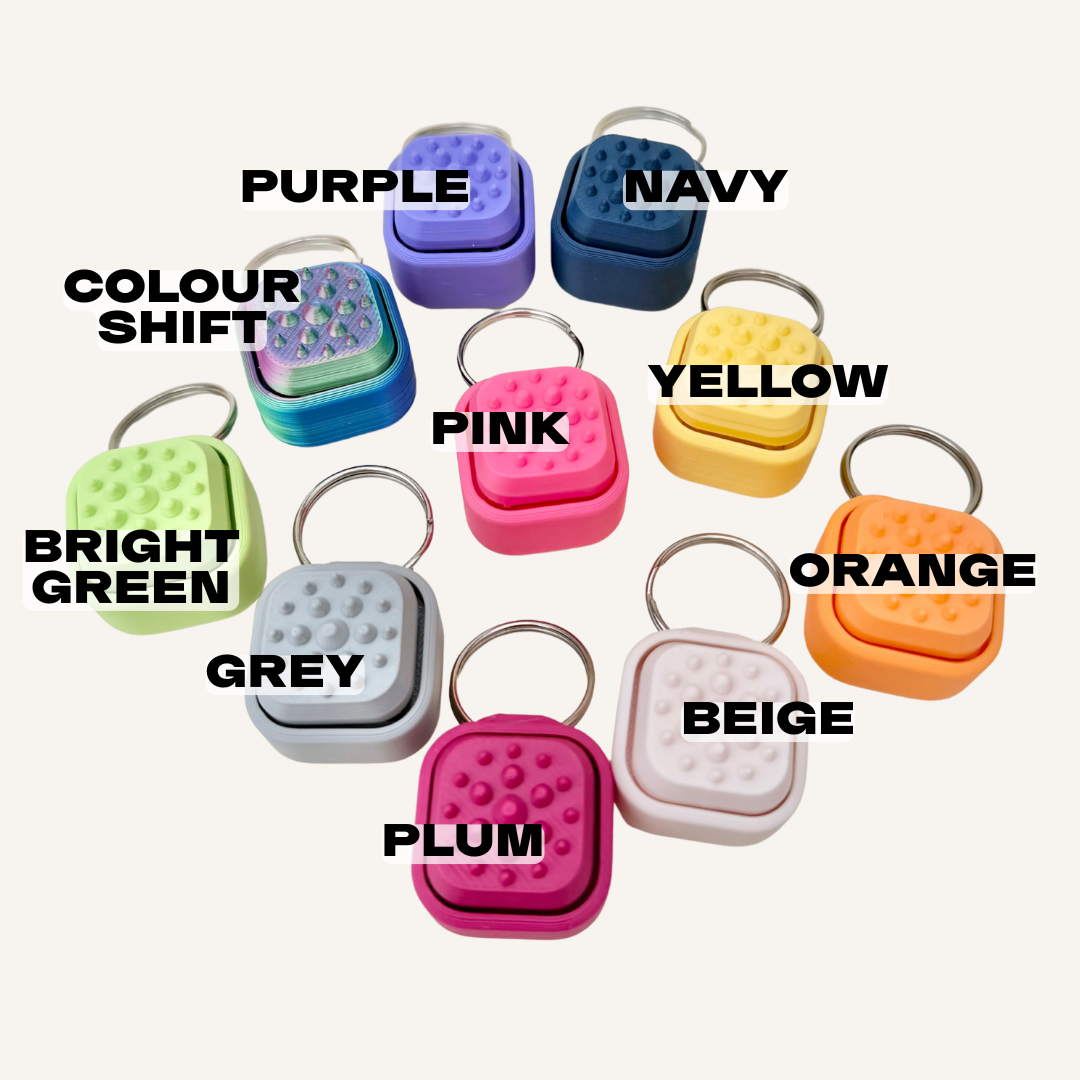 One-tile tactile clicker attachment designed for quick access stimming and sensory regulation on the go.
