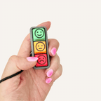 Portable feelings clicker with pressable buttons for emotional regulation, communication and busy hands.