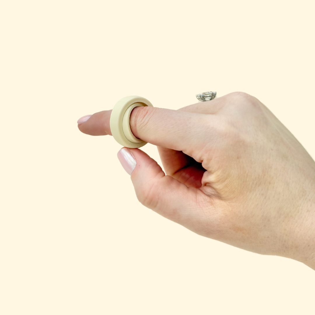 FidgiRing being worn on a finger, demonstrating its comfortable fit and spinning functionality for focus and relaxation.