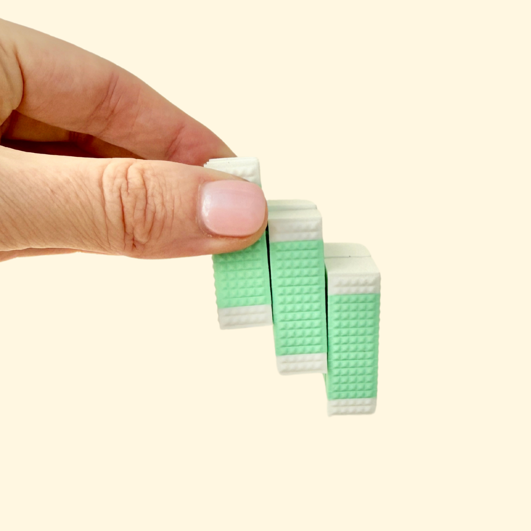 A compact square fidget toy with 9 flexible rectangles, featuring a bumpy texture for tactile stimulation.