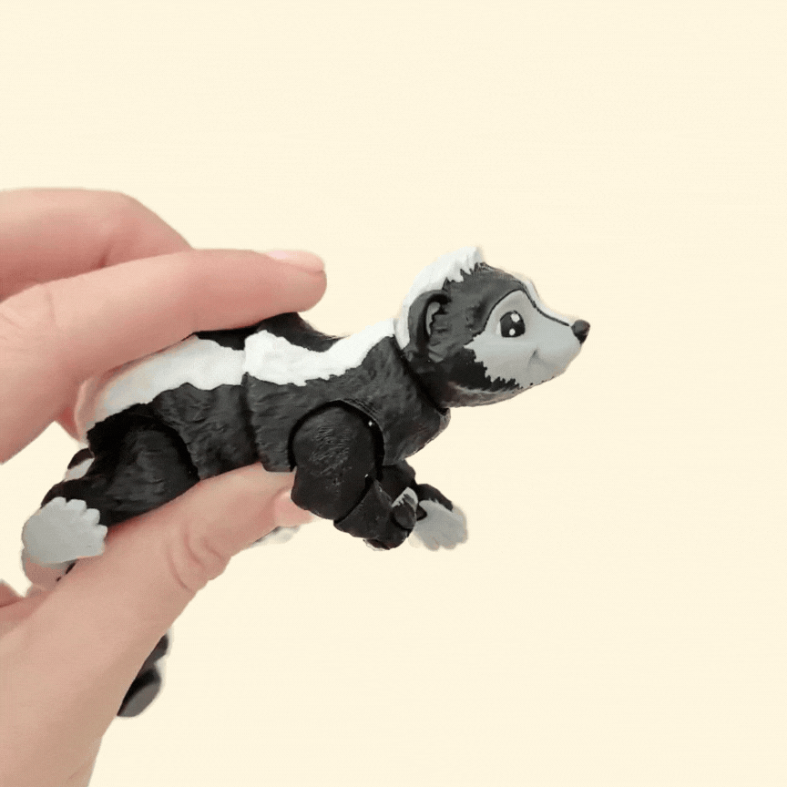 A sensory-friendly skunk fidget toy featuring a flexible tail, rotating head, and adjustable limbs for interactive play.