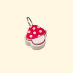 Small toadstool fidget keyring with smooth press top.
