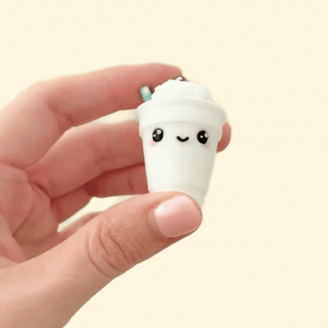 A coffee-themed fidget toy shaped like a frappe with a whipped cream top and straw, featuring a clicker.