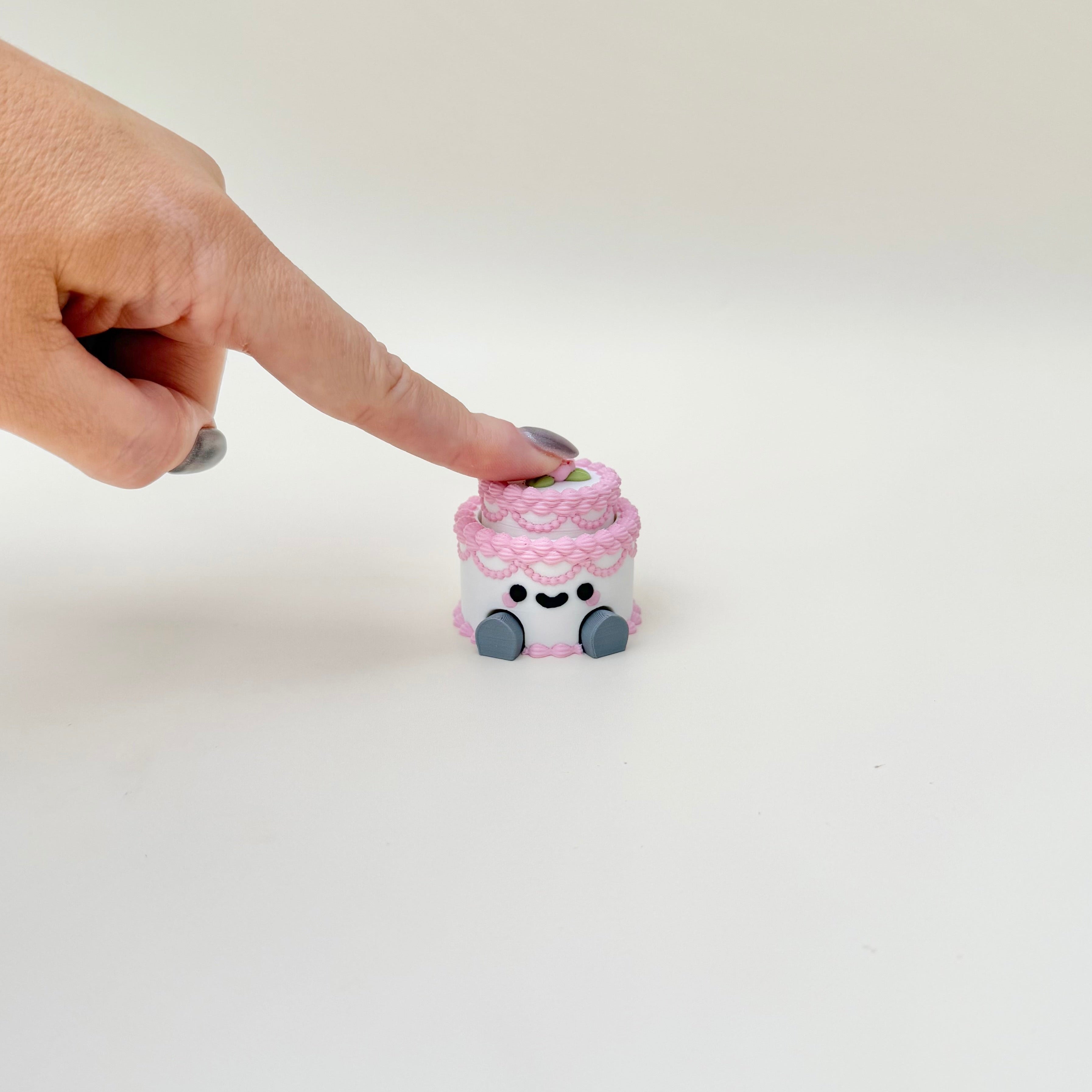 Desk-friendly clicker fidget with textured icing details and a press-down top for satisfying clicks.
