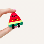 Fruit-themed clicker fidget with smooth texture, press feedback and portable sensory use.