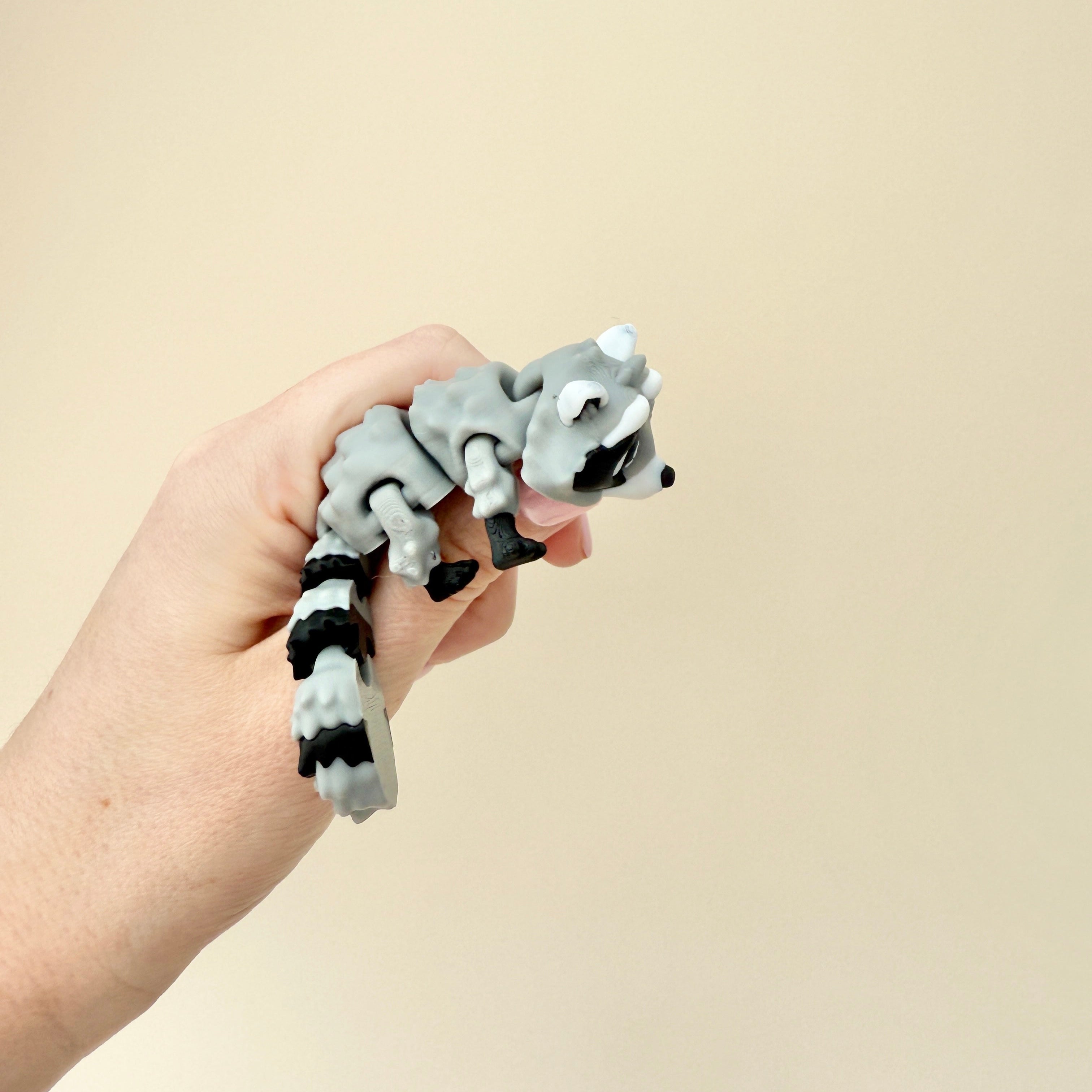 A unique fidget toy set featuring a raccoon and trash bin, great for sensory engagement and stress relief.