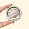 Quiet multi-ring fidget spinner with fuzzy-textured outer rim for grippy thumb rolls and calming tactile input.
