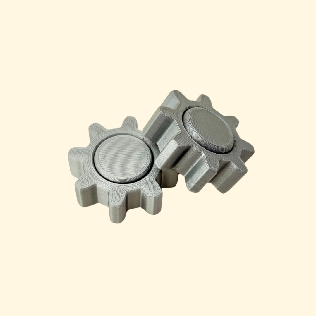 Compact gear-edge fidget spinner with textured rim and smooth low-noise spin; approx 4.4 cm.
