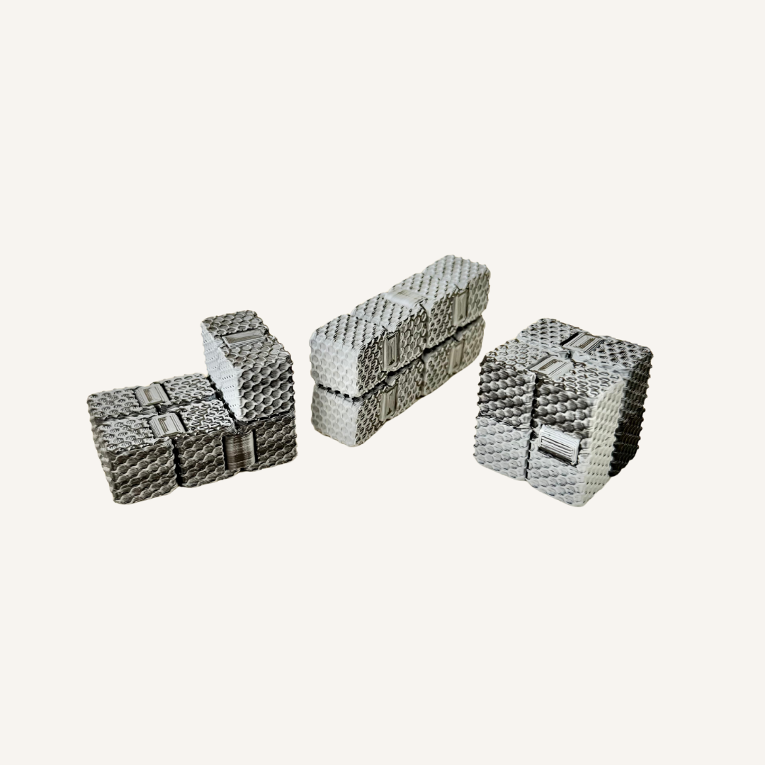 Pocket-sized textured sensory fidget with a subtle black grey and white colour shifting finish.