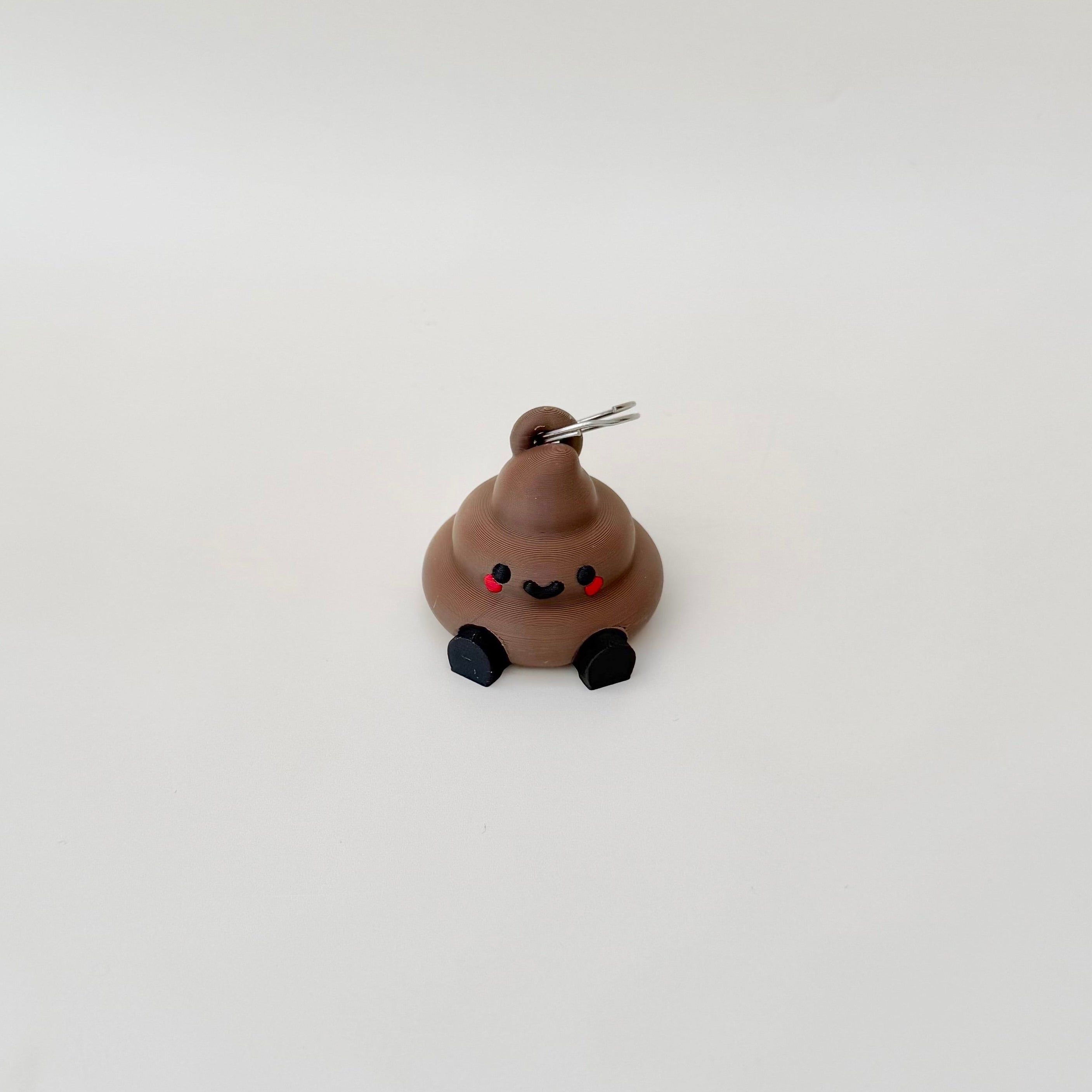 Novelty poop charm with moving legs and keyring attachment, ideal for light-hearted sensory comfort and everyday carry.

