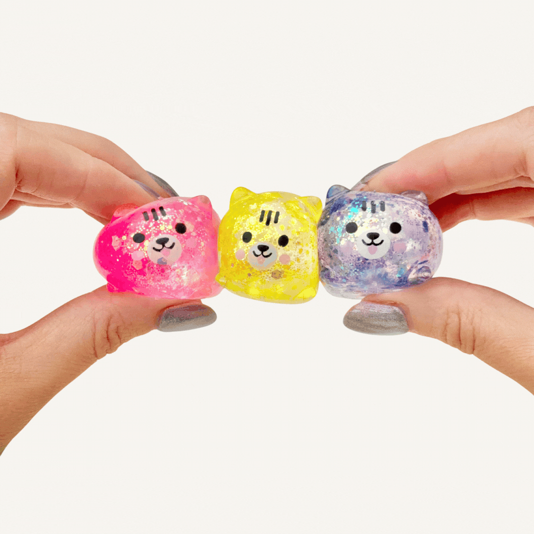 Set of three small squishy sensory fidgets with smooth feel and visual glitter effect, designed for calming squeezes and focus.
