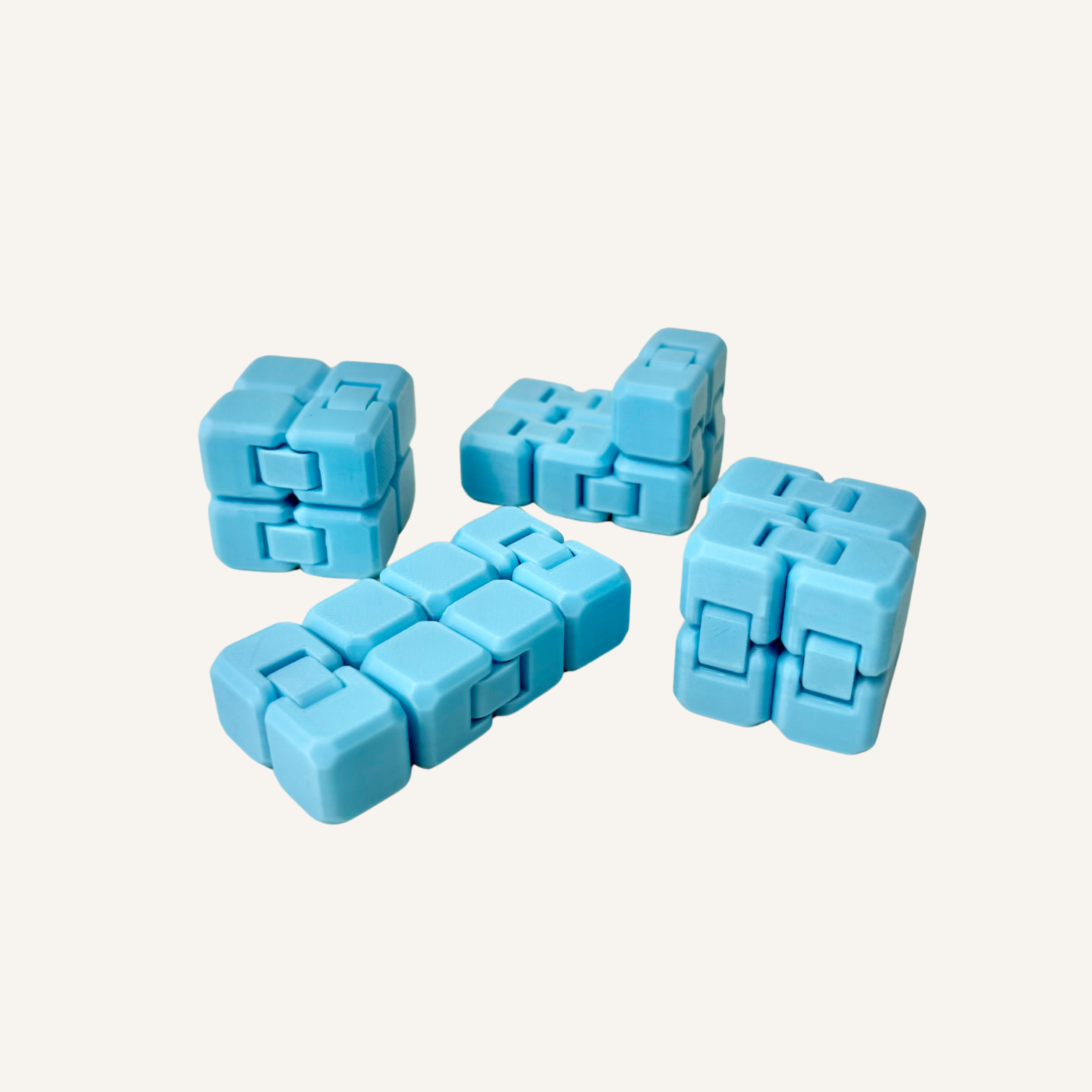 Blue glow in the dark mini infinity cube folded into its compact cube shape.