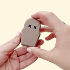 compact collectable with raised textures and gentle visual glow for grounding
