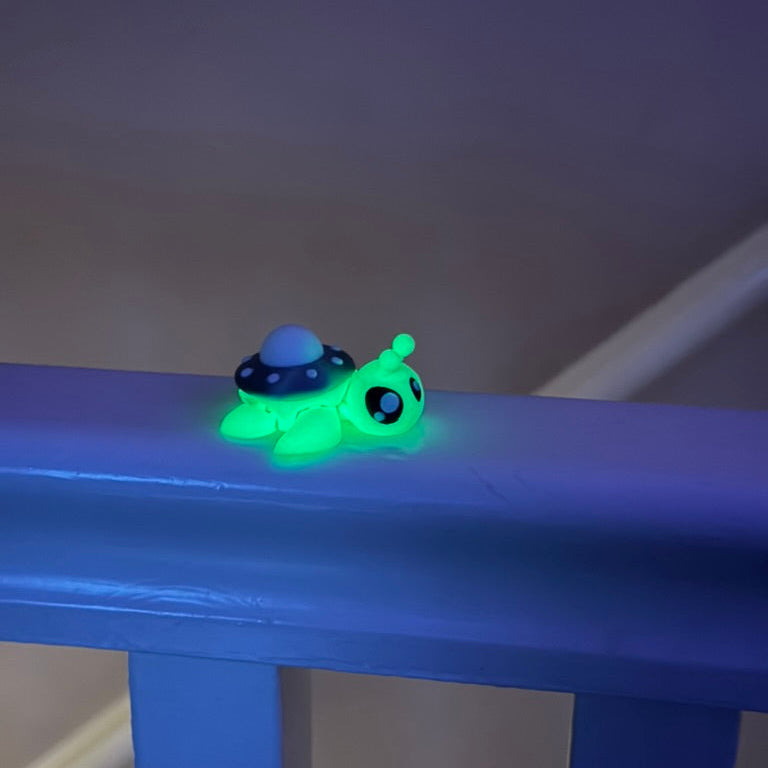 Small flexible turtle sensory toy with glow detail and textured articulated movement