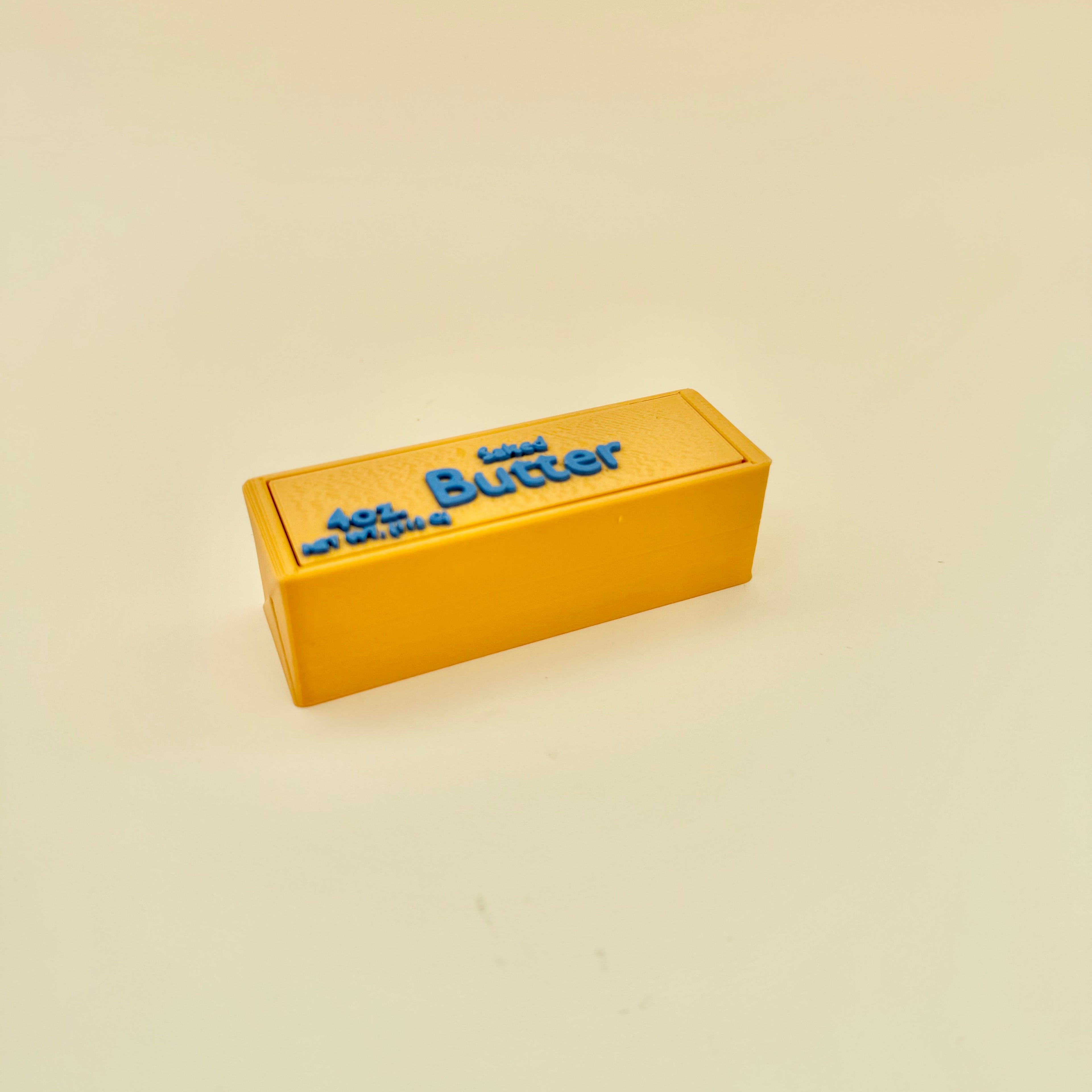 Smooth gold clicker with raised lettering, double press feedback and portable sensory use.
