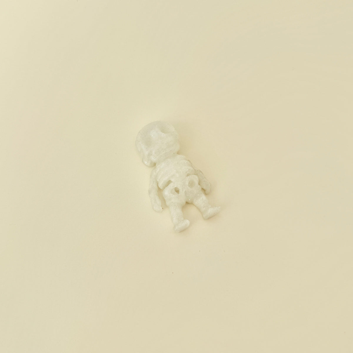 Small skeleton fidget with movable joints and sparkly frosted finish
