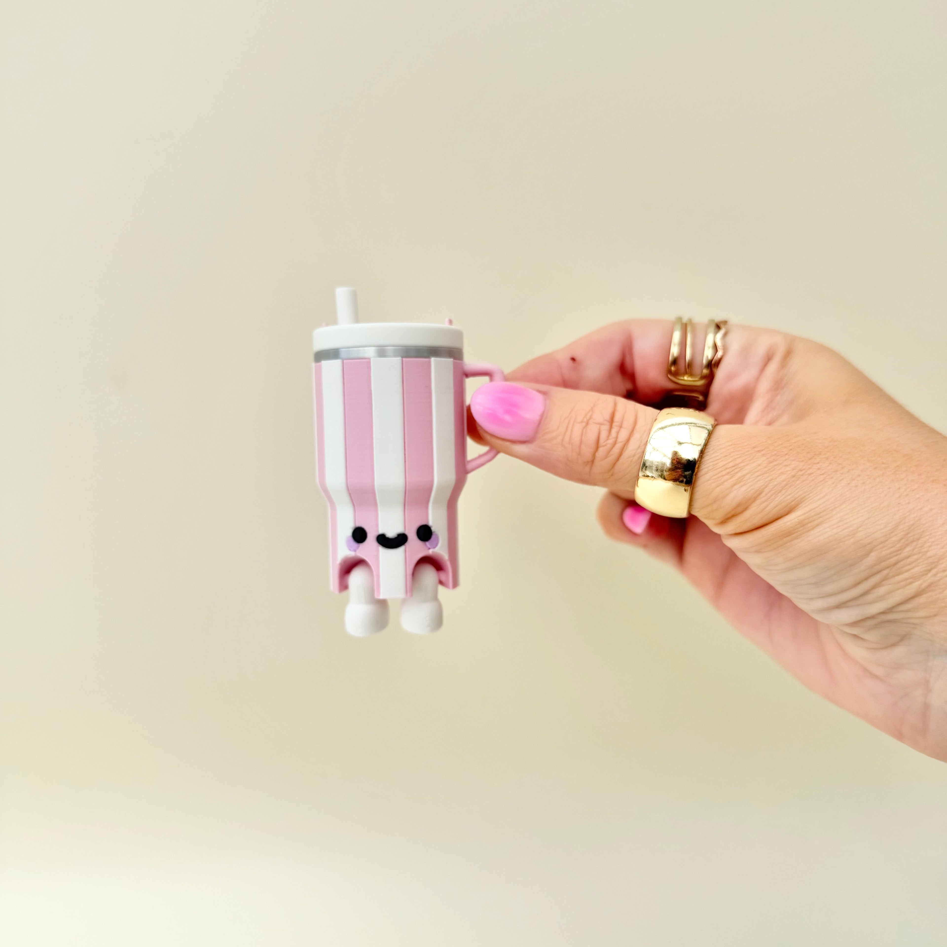 Small handled cup clicker with tactile details, pressable feedback and collectable sensory fidget design.
