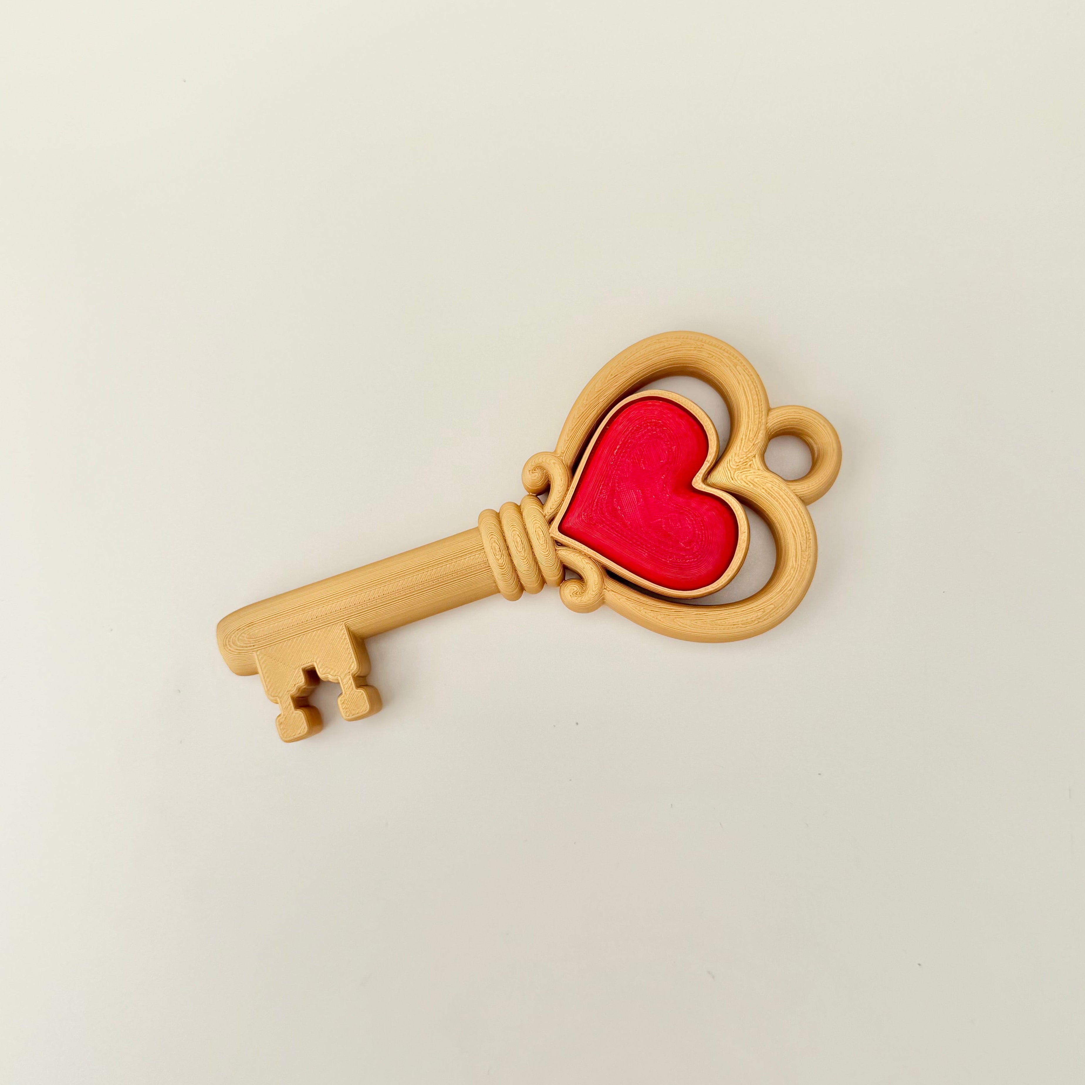 Large key shaped sensory clicker with translucent centre designed for tactile feedback and grounding hand movement.
