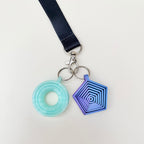 Visual fidget charm that shifts as you move it, made for lanyards with smooth tactile movement and focus support.
