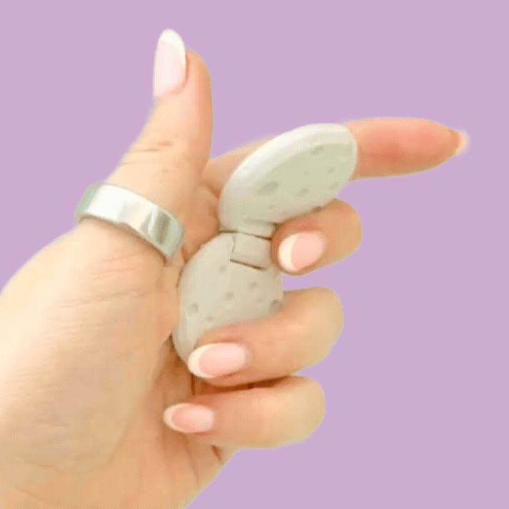 Two light grey cratered moons connected by a hinge for repetitive sensory movement.