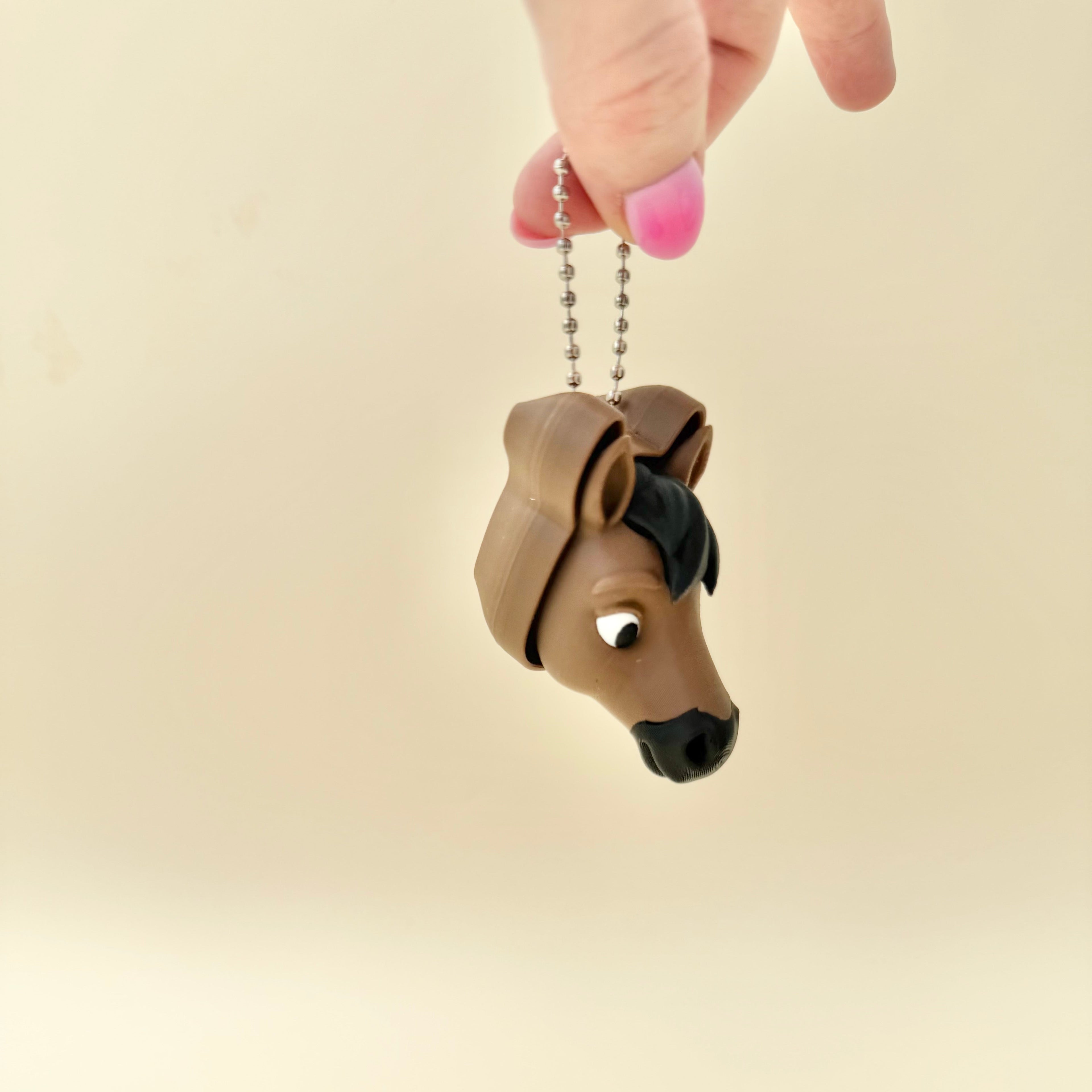 Horse-themed sensory tool with metal attachment, tactile click feedback and neurodivergent-friendly use.
