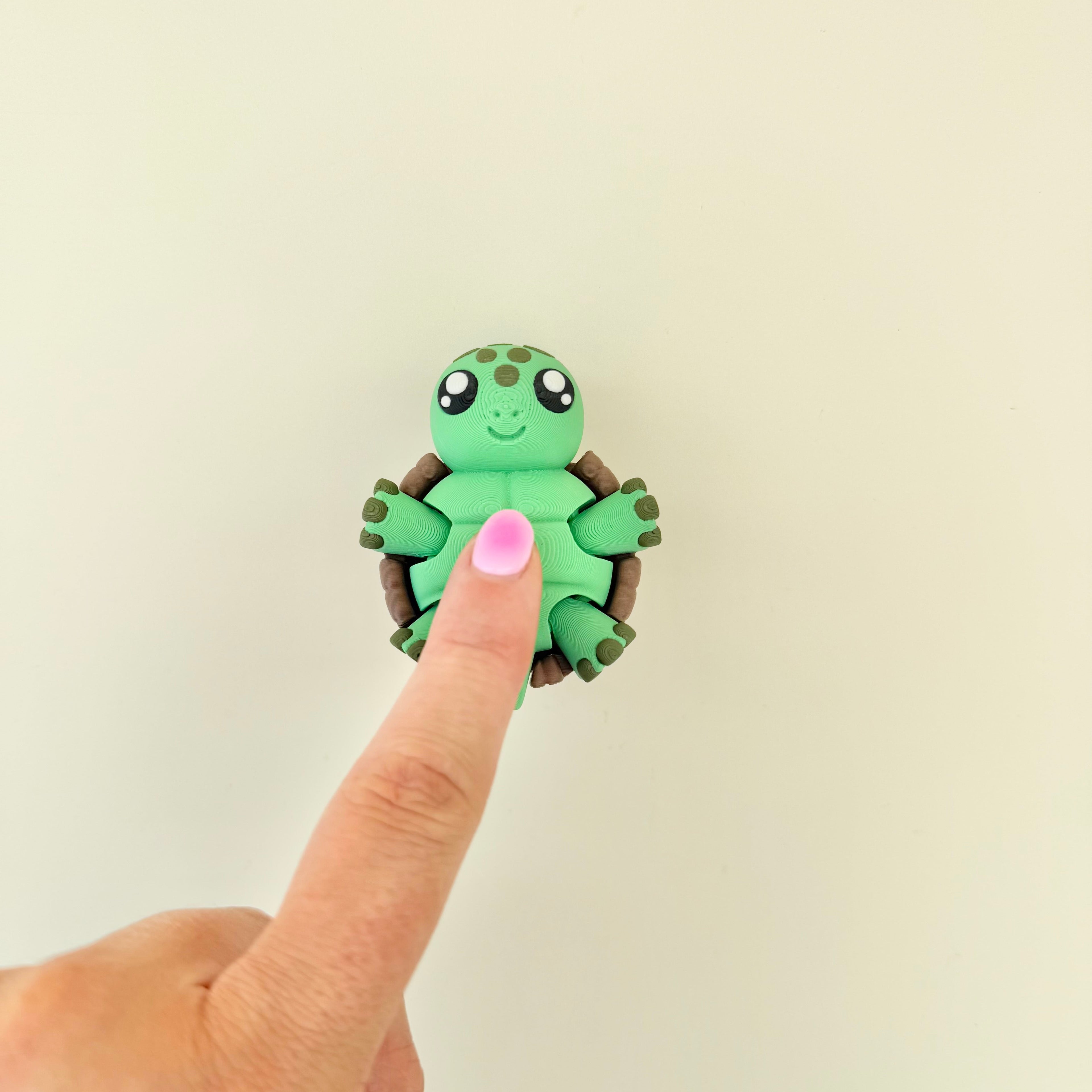 Turtle sensory fidget with moving legs and wrist strap for grounding, busy hands and everyday regulation.