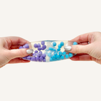 Smooth squish ball fidget with water and firm beads inside, designed for quick squeeze feedback and tactile stimulation.
