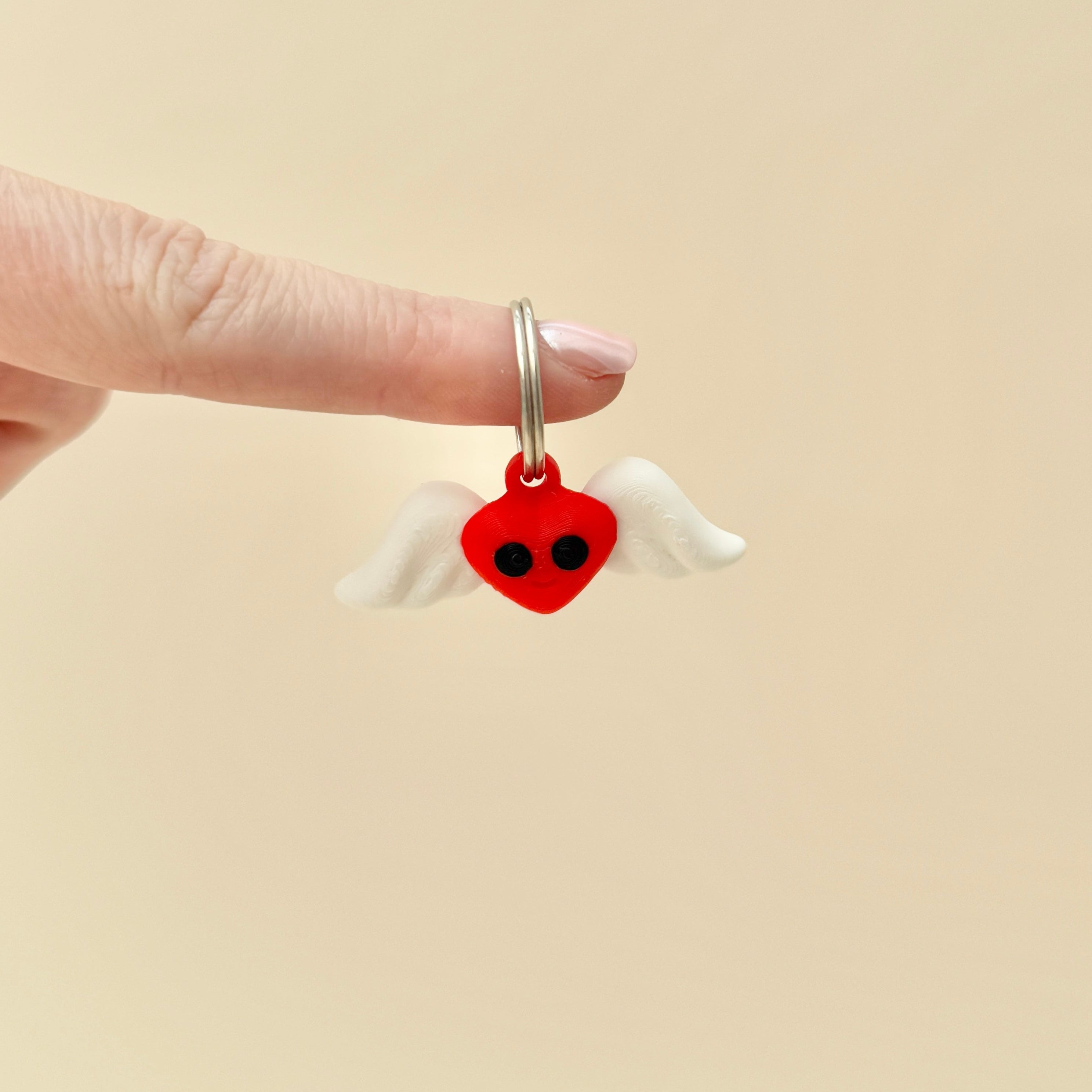 A small flying heart keyring that moves and shakes, perfect for fidgeting or gifting.
