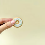 A two-piece magnetic fidget doughnut that flips and spins in hand, providing a satisfying sensory experience.
