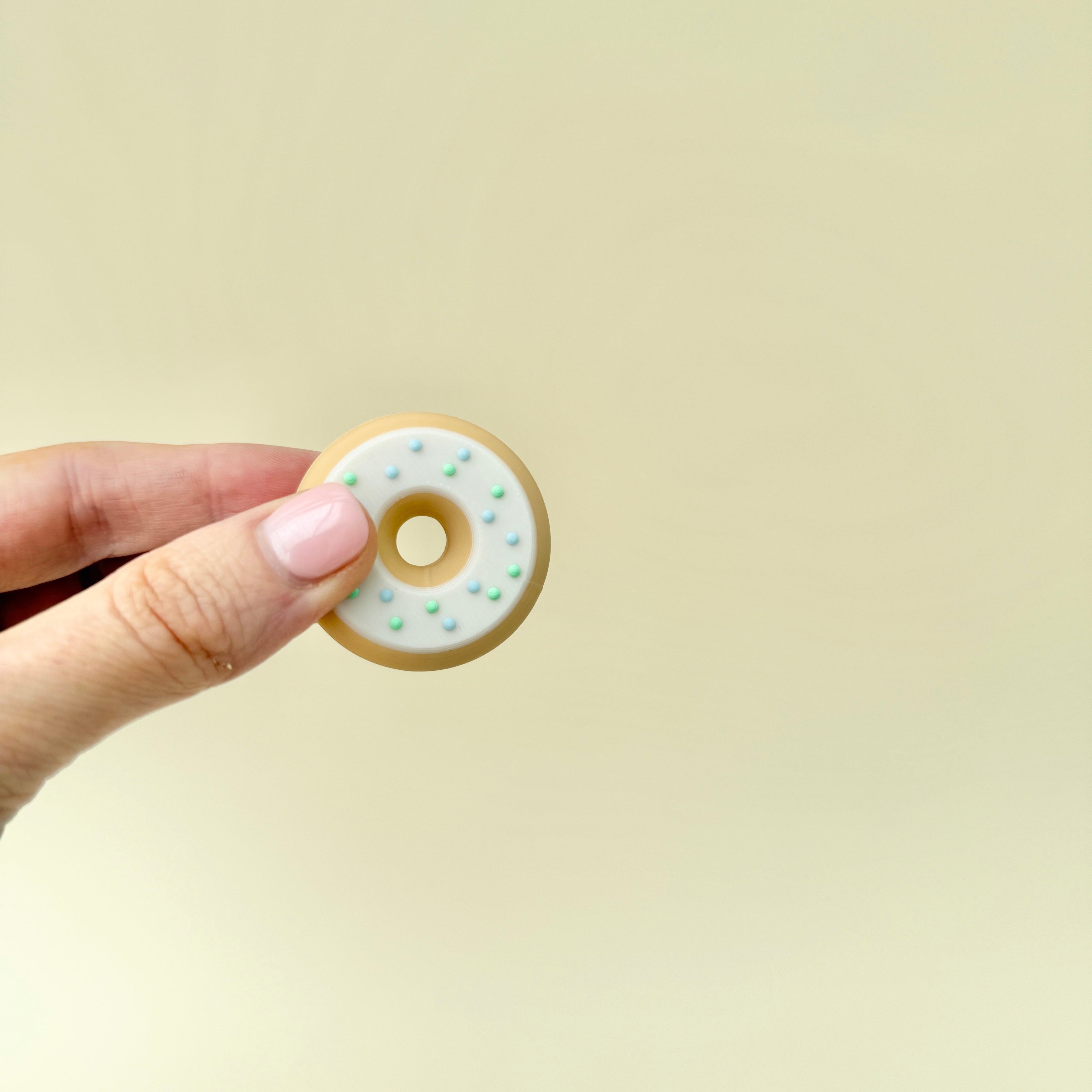 A two-piece magnetic fidget doughnut that flips and spins in hand, providing a satisfying sensory experience.