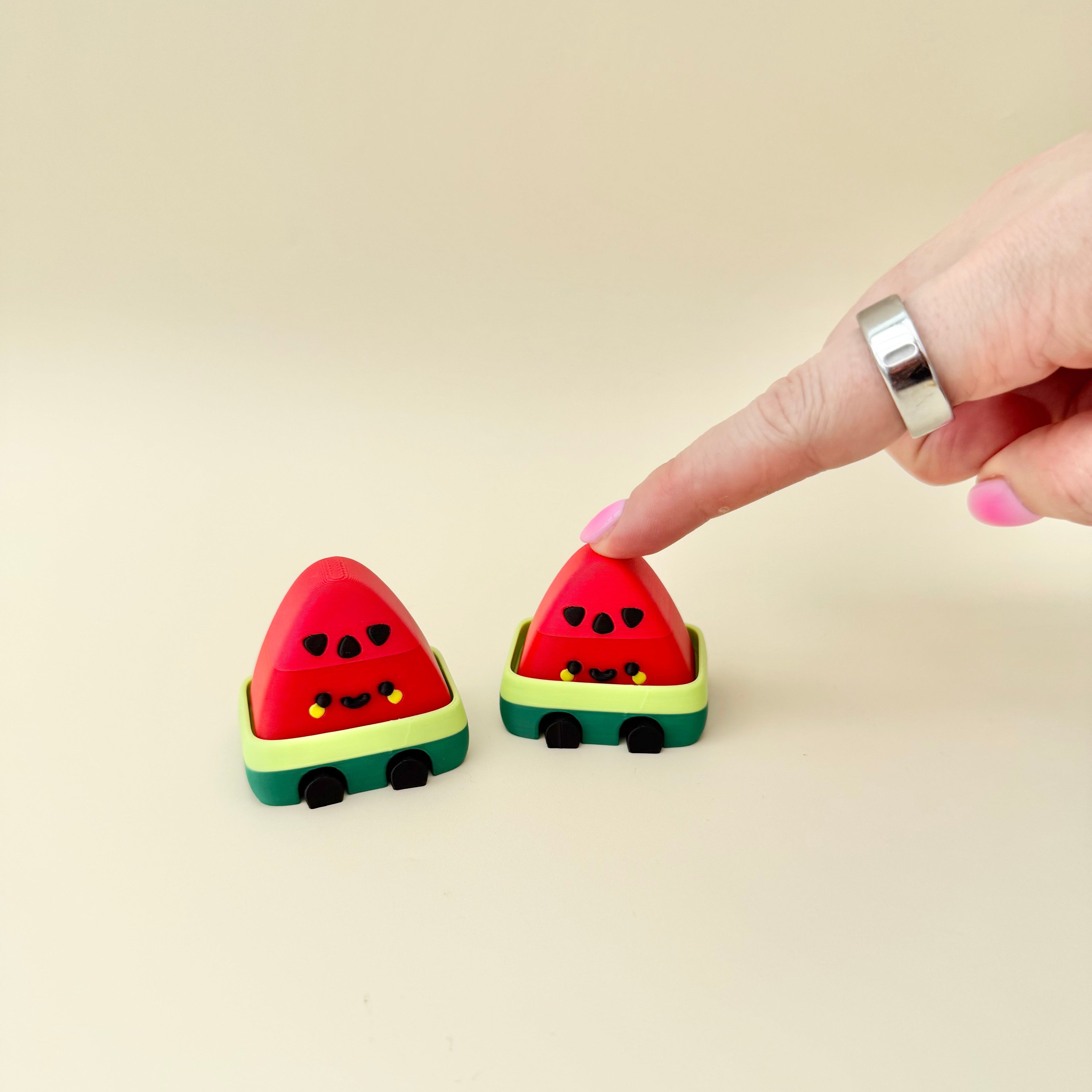 Bright watermelon clicker with tactile details and repetitive pressing for grounding and regulation.
