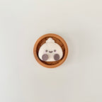 Novelty dumpling clicker fidget that looks like desk decor but works as a satisfying sensory tool.
