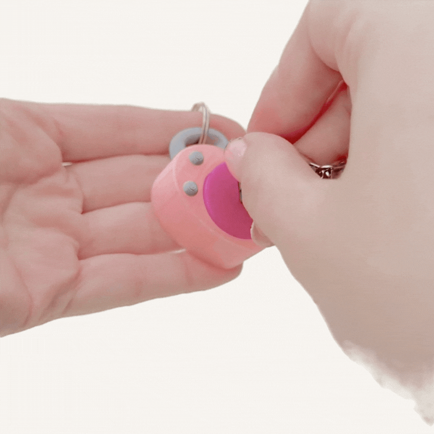 Portable heart lock clicker with key attachment and clip for discreet fidgeting on the go.
