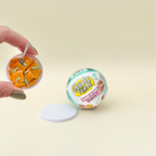 Surprise capsule with a mini make-and-display project for kids who enjoy collecting and creative play
