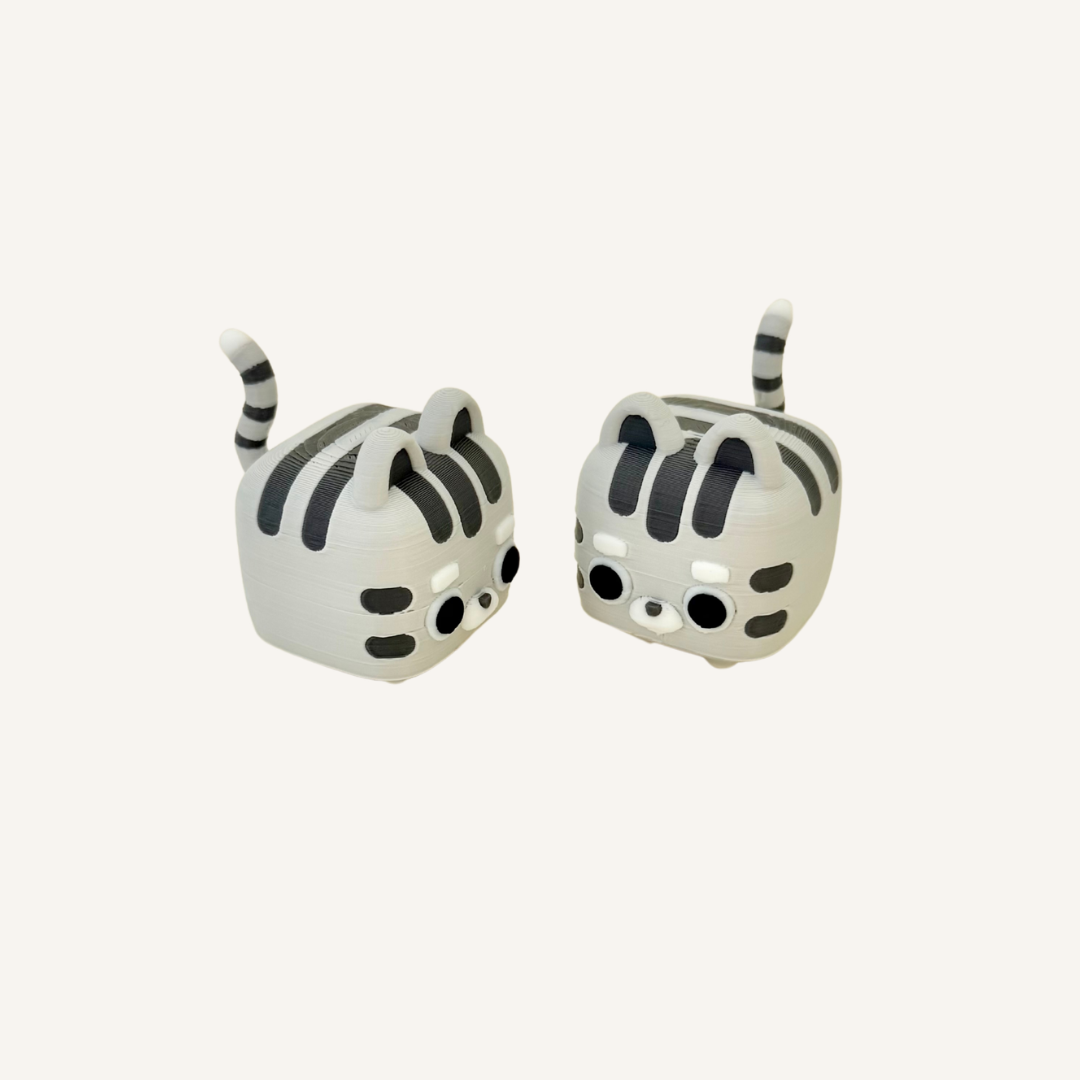 Small kitty clicker for tactile input, quiet or louder click feedback and neurodivergent-friendly fidgeting.