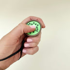 Palm-size fruit clicker providing light pain-stim and trace-stim feedback.
