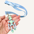 Portable robot fidget attachment for lanyards and bags, designed for repetitive movement and tactile input.