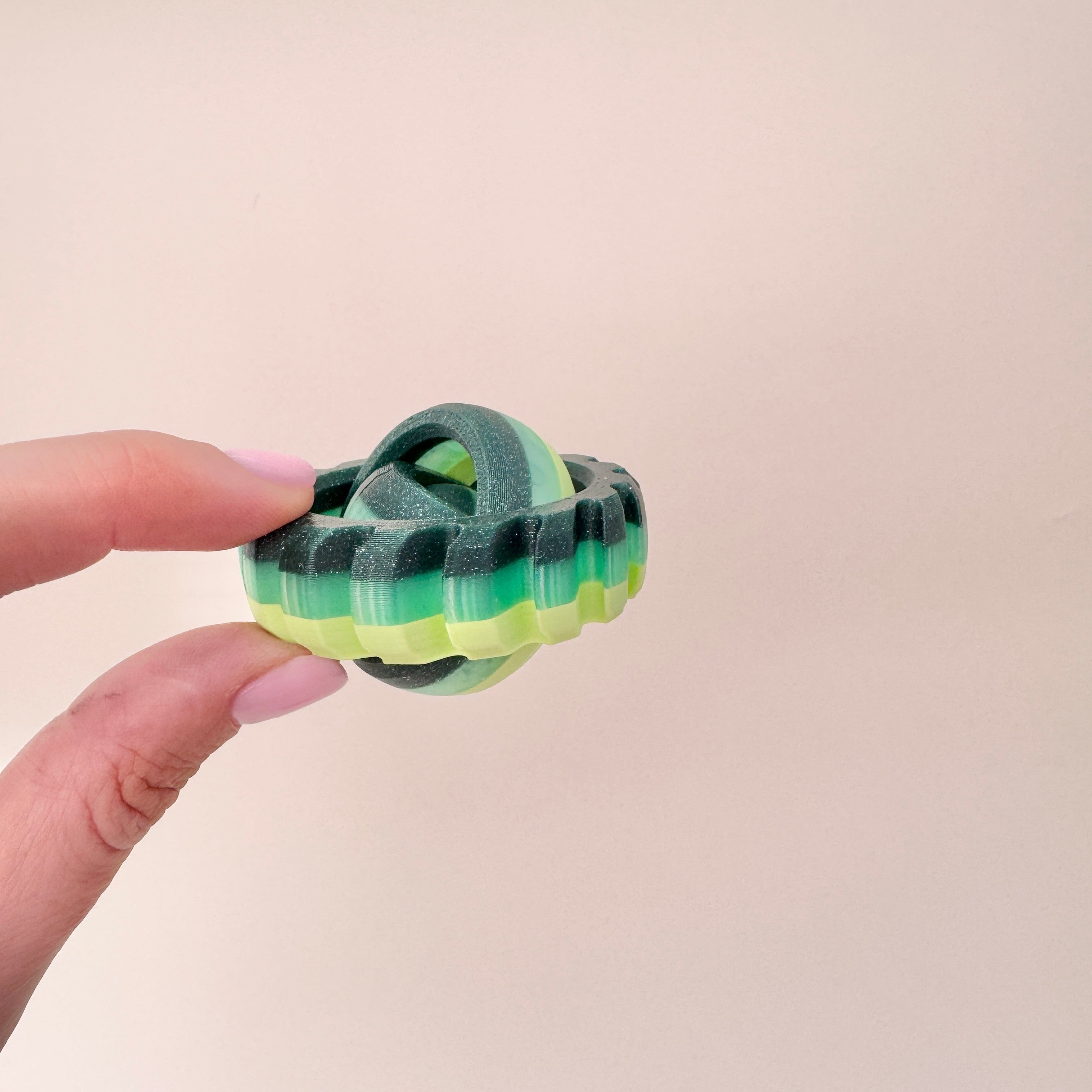 multi-green sensory spinner with rotating centre and tactile rim
