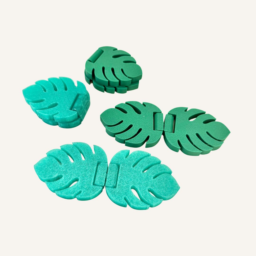 Monstera leaf hand fidget designed for flipping, folding, twisting and repetitive sensory movement.